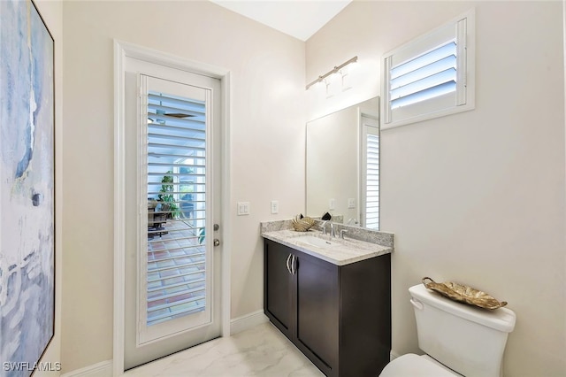 27080 Flamingo Dr, Bonita Springs, FL 34135 - bathroom with toilet, baseboards, and vanity
