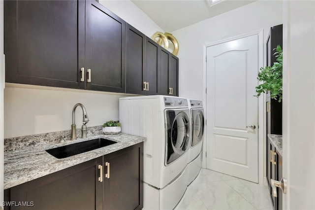 27080 Flamingo Dr, Bonita Springs, FL 34135 - washroom with washing machine and clothes dryer, a sink, marble finish floor, and cabinet space