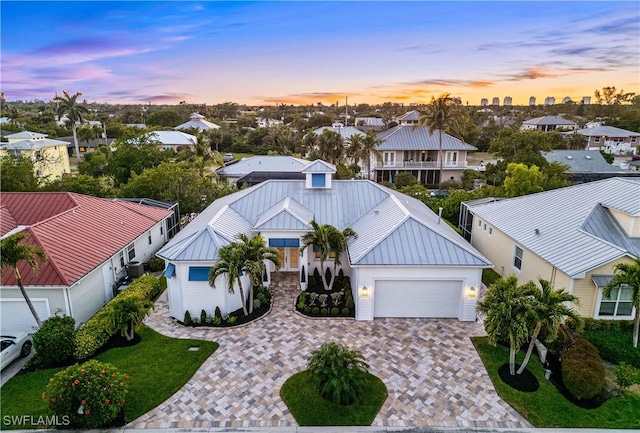 27080 Flamingo Dr, Bonita Springs, FL 34135 - view of front facade featuring decorative driveway, a residential view, and metal roof