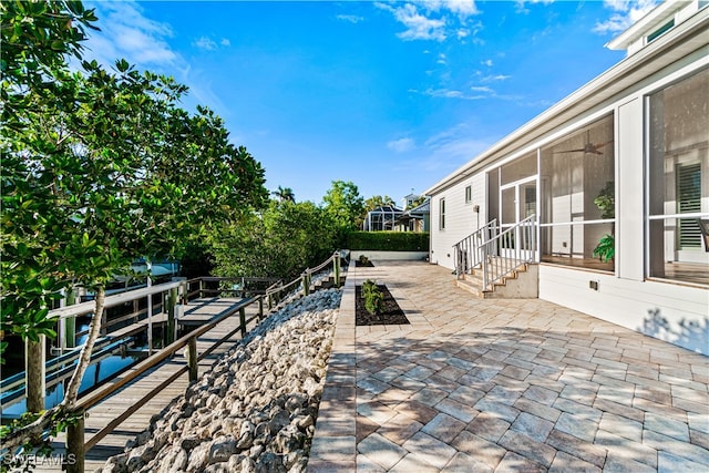 27080 Flamingo Dr, Bonita Springs, FL 34135 - view of patio featuring a sunroom, a ceiling fan, and entry steps