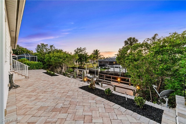 27080 Flamingo Dr, Bonita Springs, FL 34135 - patio terrace at dusk featuring glass enclosure