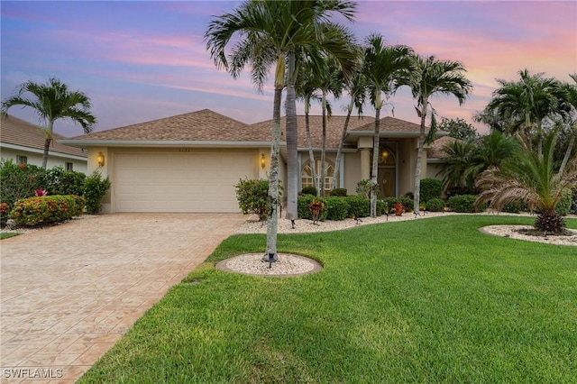 5131 SW 19th Ave, Cape Coral, FL 33914 - ranch-style house featuring a garage, stucco siding, a front lawn, and decorative driveway