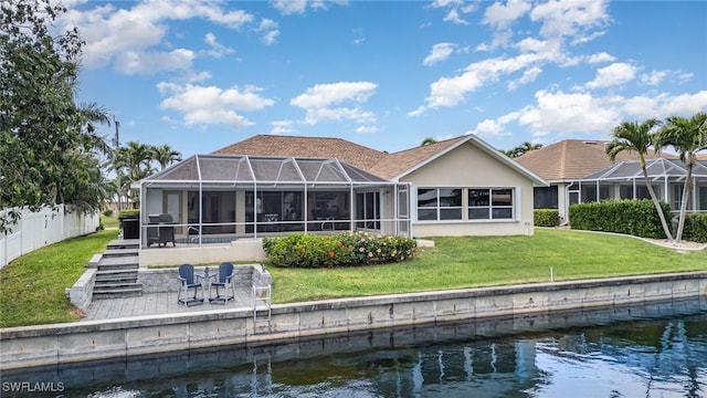 5131 SW 19th Ave, Cape Coral, FL 33914 - back of house featuring stucco siding, a water view, a patio area, fence, and a lanai