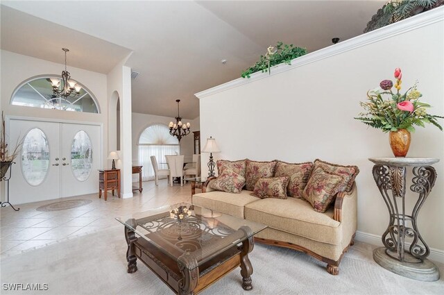 5131 SW 19th Ave, Cape Coral, FL 33914 - tiled living area with french doors, an inviting chandelier, visible vents, and high vaulted ceiling