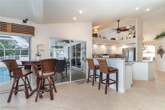 5131 SW 19th Ave, Cape Coral, FL 33914 - interior space with recessed lighting, lofted ceiling, ceiling fan with notable chandelier, and light tile patterned flooring