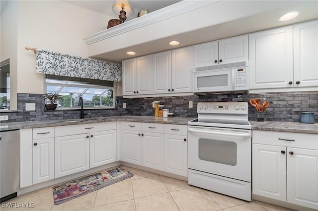 5131 SW 19th Ave, Cape Coral, FL 33914 - kitchen with a sink, light tile patterned floors, backsplash, and white appliances