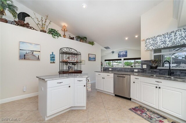 5131 SW 19th Ave, Cape Coral, FL 33914 - kitchen featuring vaulted ceiling, white cabinetry, backsplash, stainless steel dishwasher, and a sink