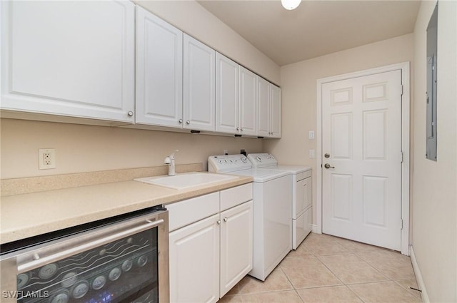 5131 SW 19th Ave, Cape Coral, FL 33914 - washroom featuring light tile patterned flooring, washing machine and clothes dryer, a sink, baseboards, and cabinet space