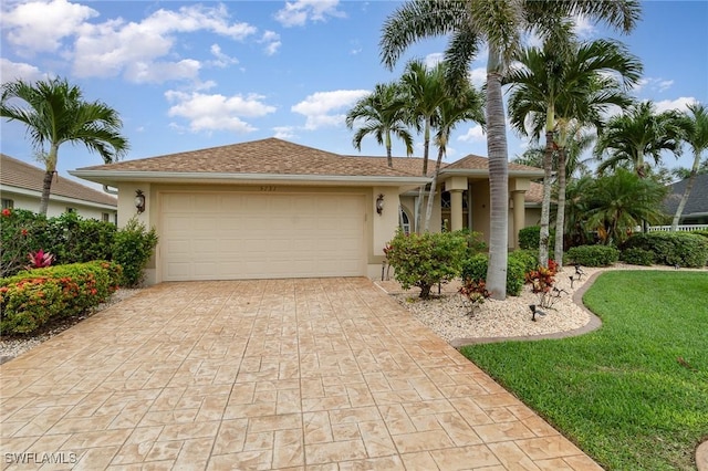 5131 SW 19th Ave, Cape Coral, FL 33914 - ranch-style home with a front lawn, a garage, driveway, and stucco siding