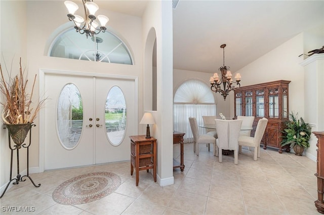 5131 SW 19th Ave, Cape Coral, FL 33914 - entryway featuring arched walkways, a chandelier, french doors, high vaulted ceiling, and light tile patterned flooring