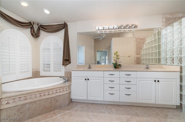 5131 SW 19th Ave, Cape Coral, FL 33914 - full bath featuring a sink, a bath, double vanity, and tile patterned flooring