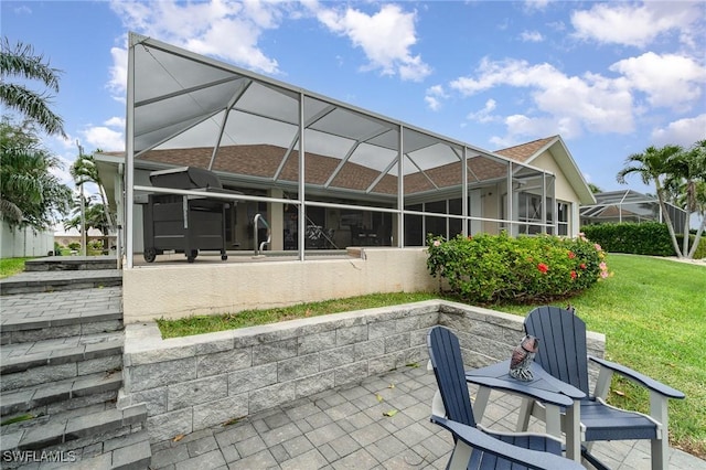 5131 SW 19th Ave, Cape Coral, FL 33914 - back of house featuring a patio, glass enclosure, and a lawn