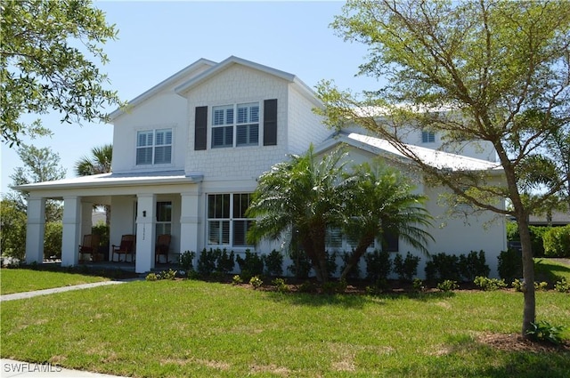 view of front of house featuring a front lawn and covered porch