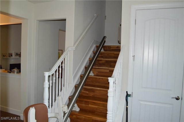 staircase featuring wood finished floors