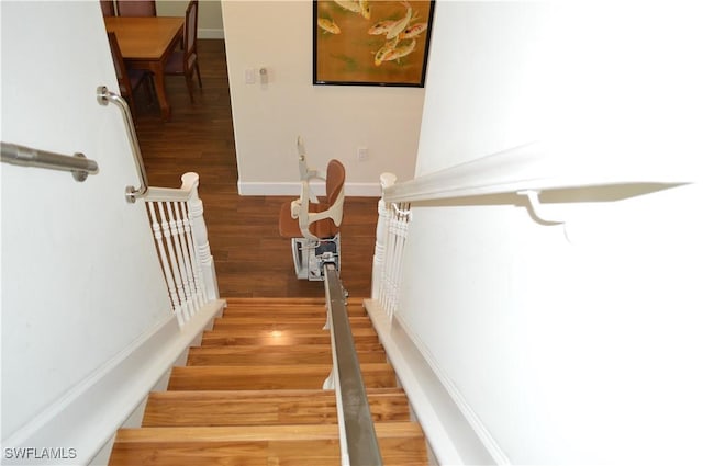 stairs with baseboards and wood finished floors