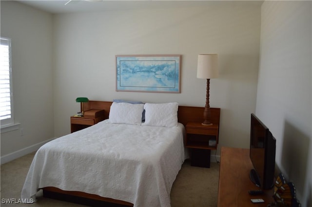 bedroom featuring carpet floors and baseboards