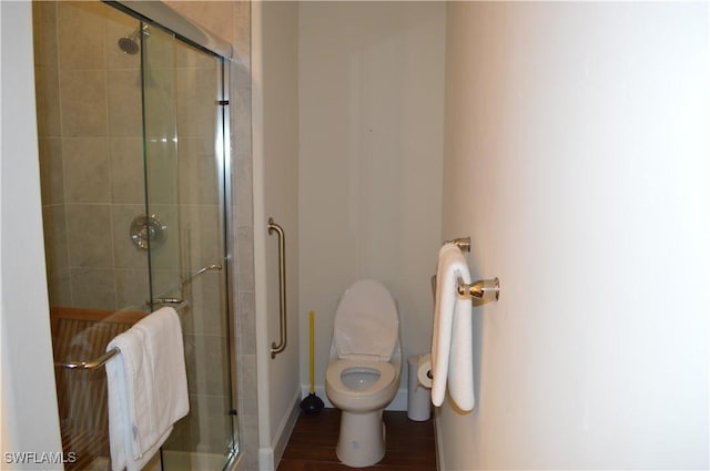 full bathroom with a shower stall and toilet