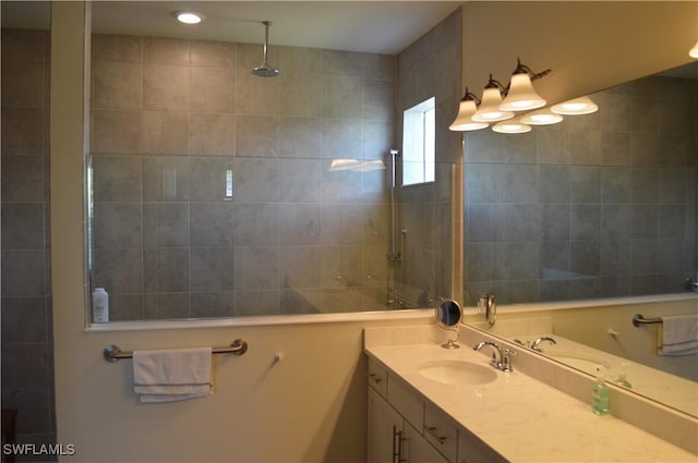 full bathroom with walk in shower and vanity