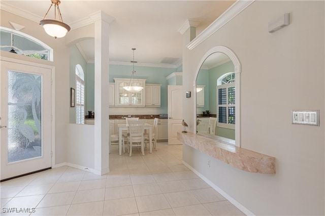 8815 Naples Heritage Dr Unit D9, Naples, FL 34112 - foyer entrance featuring arched walkways, light tile patterned floors, baseboards, and crown molding