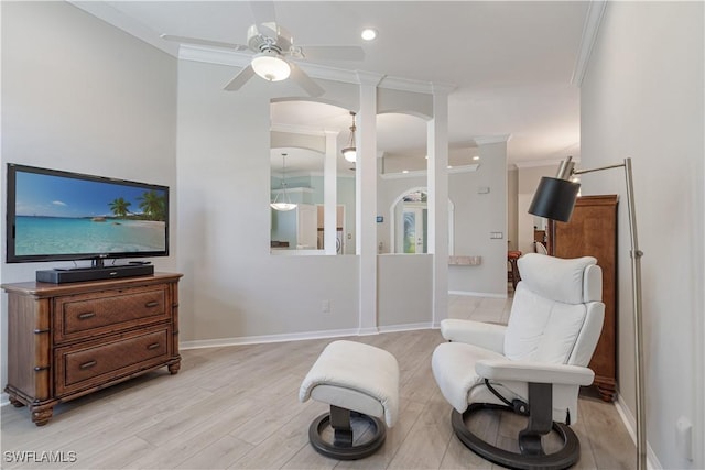 8815 Naples Heritage Dr Unit D9, Naples, FL 34112 - living area featuring ceiling fan, arched walkways, ornamental molding, light wood finished floors, and baseboards