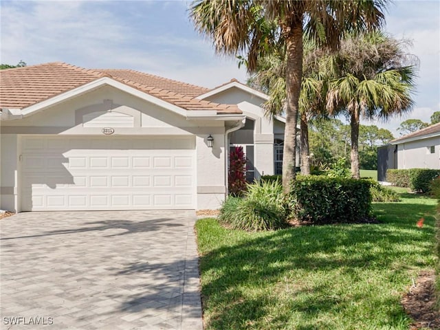 8815 Naples Heritage Dr Unit D9, Naples, FL 34112 - view of front of home with an attached garage, stucco siding, a front yard, and decorative driveway