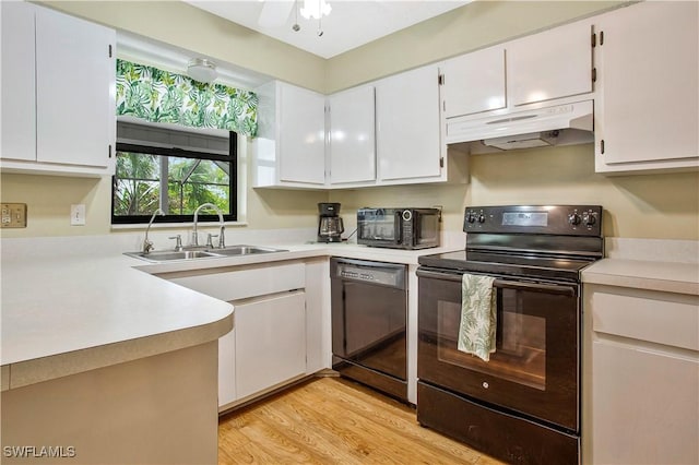 kitchen with black appliances, a sink, under cabinet range hood, light countertops, and white cabinets