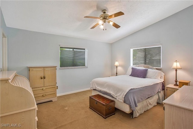 bedroom featuring lofted ceiling, light carpet, ceiling fan, and baseboards