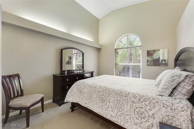 28750 Diamond Dr Unit 205, Bonita Springs, FL 34134 - bedroom with baseboards, high vaulted ceiling, and light carpet