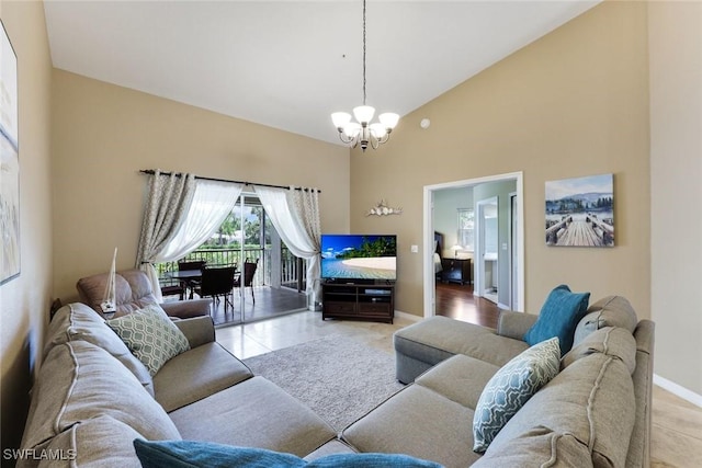 28750 Diamond Dr Unit 205, Bonita Springs, FL 34134 - tiled living room with baseboards, a chandelier, and high vaulted ceiling
