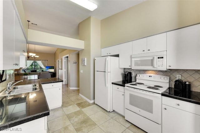 28750 Diamond Dr Unit 205, Bonita Springs, FL 34134 - kitchen featuring white cabinets, a sink, white appliances, a chandelier, and tasteful backsplash