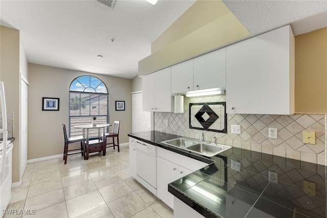 28750 Diamond Dr Unit 205, Bonita Springs, FL 34134 - kitchen featuring decorative backsplash, dishwasher, a sink, baseboards, and white cabinets