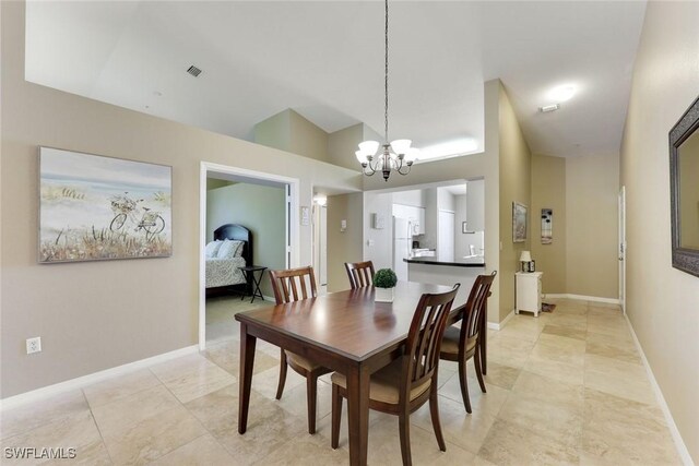 28750 Diamond Dr Unit 205, Bonita Springs, FL 34134 - dining room featuring visible vents, baseboards, lofted ceiling, and a chandelier
