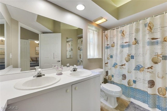 28750 Diamond Dr Unit 205, Bonita Springs, FL 34134 - bathroom featuring a sink, ensuite bathroom, toilet, and double vanity