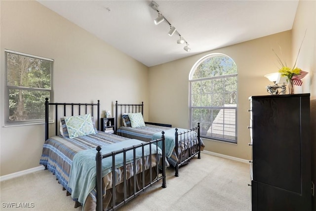 28750 Diamond Dr Unit 205, Bonita Springs, FL 34134 - carpeted bedroom featuring baseboards and rail lighting