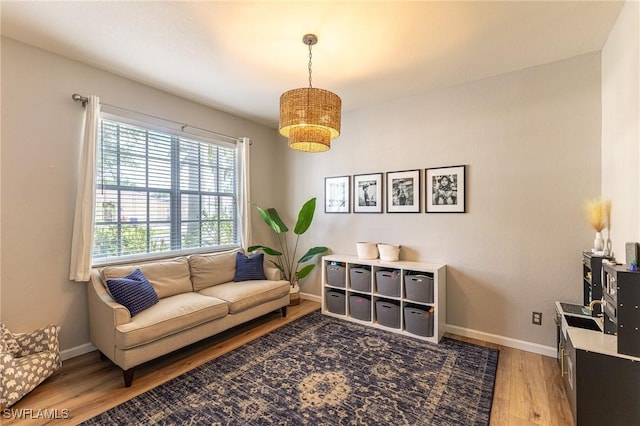 sitting room featuring light wood-style flooring and baseboards