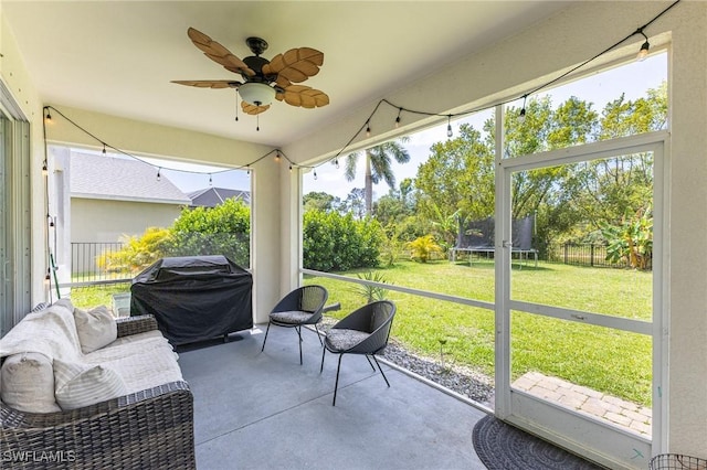 sunroom / solarium with a ceiling fan and plenty of natural light