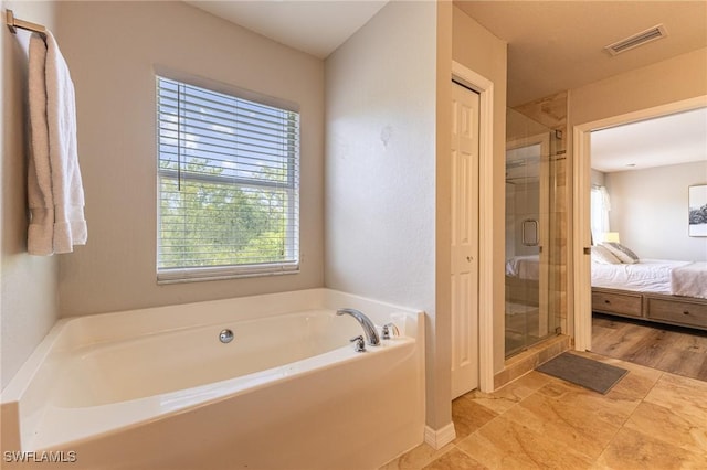 ensuite bathroom with a bath and a stall shower