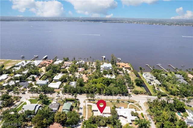 drone / aerial view featuring a residential view and a water view