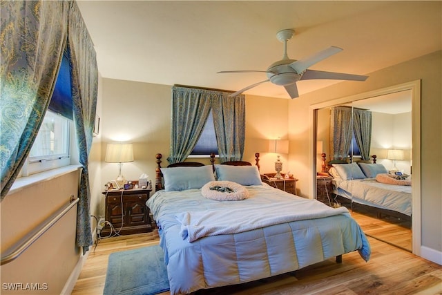 bedroom featuring ceiling fan, baseboards, and wood finished floors