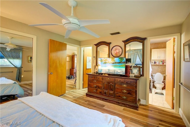 bedroom with light wood finished floors, ceiling fan, and visible vents
