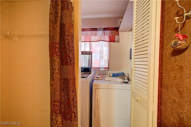washroom featuring washing machine and clothes dryer and laundry area