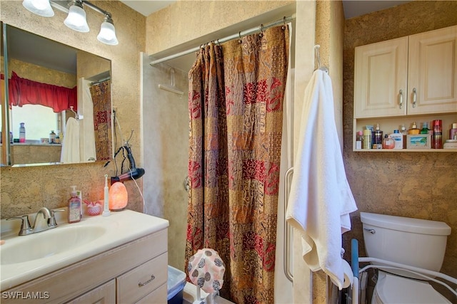 bathroom with toilet, vanity, and a shower with shower curtain