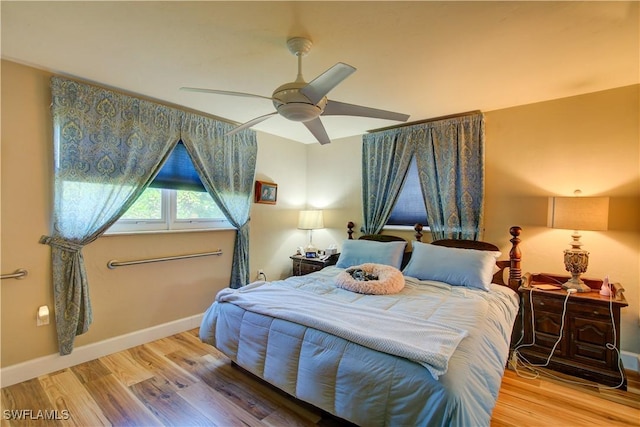 bedroom with ceiling fan, baseboards, and wood finished floors