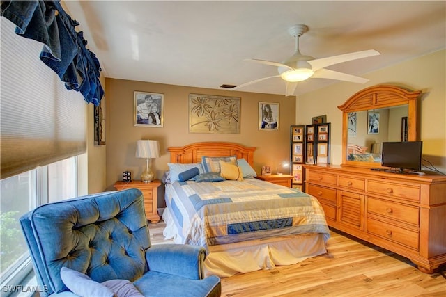 bedroom featuring light wood finished floors, a ceiling fan, and visible vents