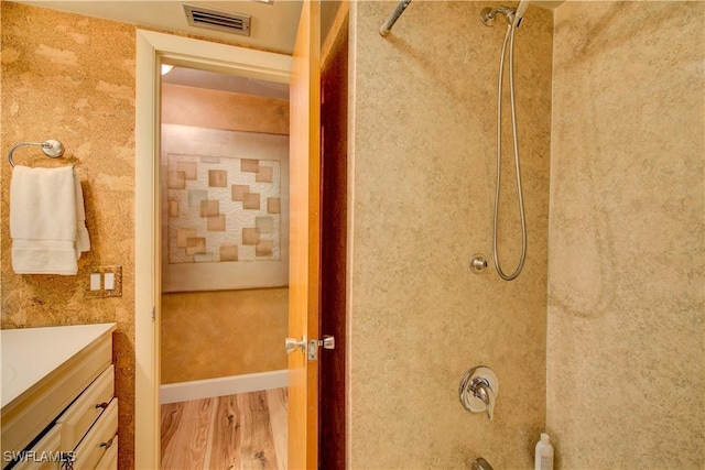 full bathroom with vanity, visible vents, and wood finished floors