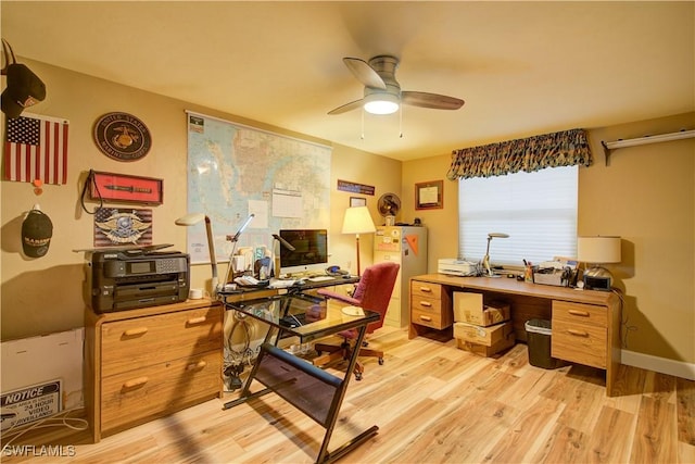 home office with a wealth of natural light, a ceiling fan, and light wood finished floors
