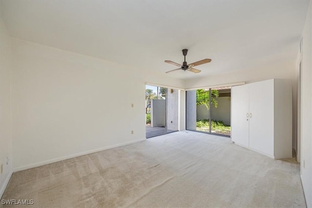 576 Retreat Dr Unit 101, Naples, FL 34110 - empty room with baseboards, light colored carpet, and a ceiling fan