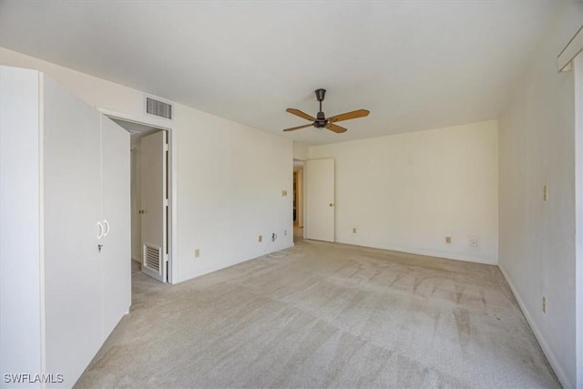 576 Retreat Dr Unit 101, Naples, FL 34110 - unfurnished room with visible vents, light colored carpet, and a ceiling fan