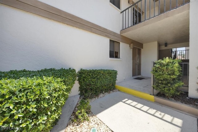 576 Retreat Dr Unit 101, Naples, FL 34110 - view of exterior entry with stucco siding
