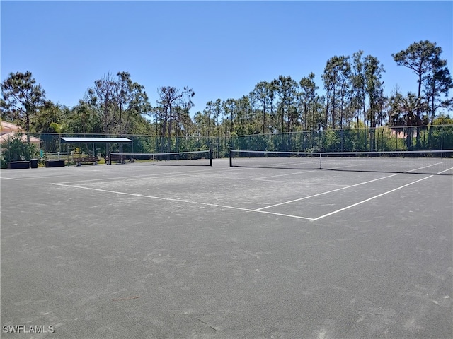 576 Retreat Dr Unit 101, Naples, FL 34110 - view of tennis court featuring community basketball court and fence
